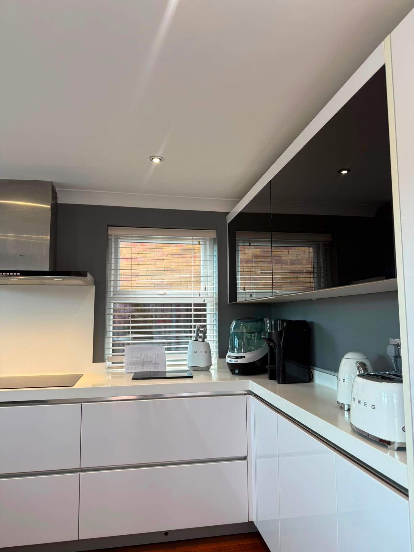 Hand cut-in paint detail around blinds and white kitchen units, Hove
