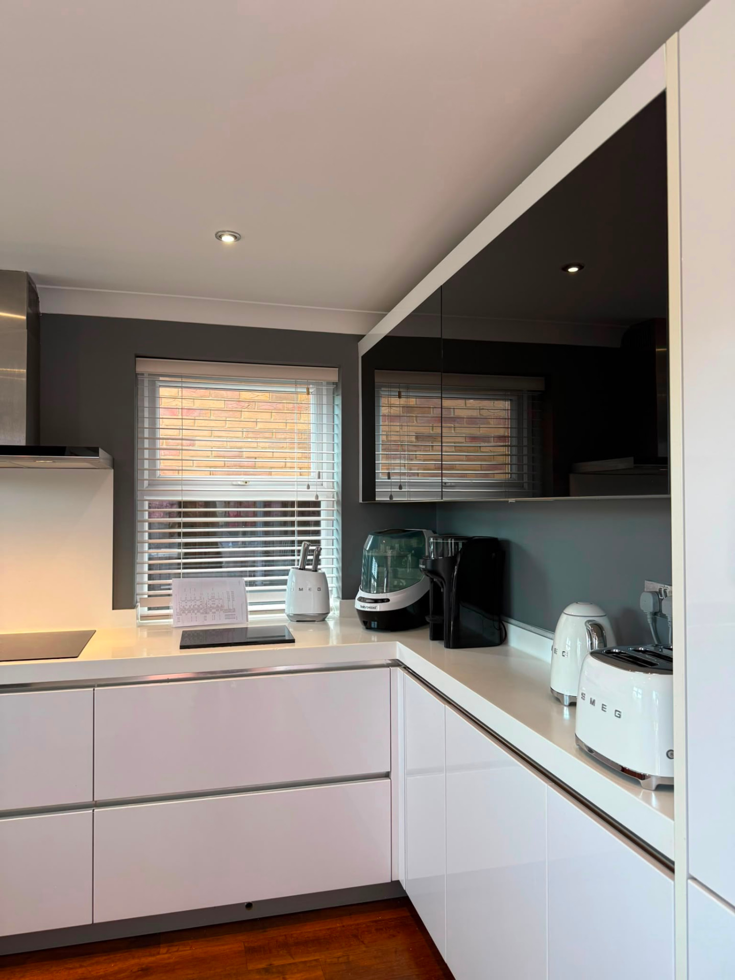 Freshly painted kitchen ceiling and splashback detail above an induction hob, Brighton