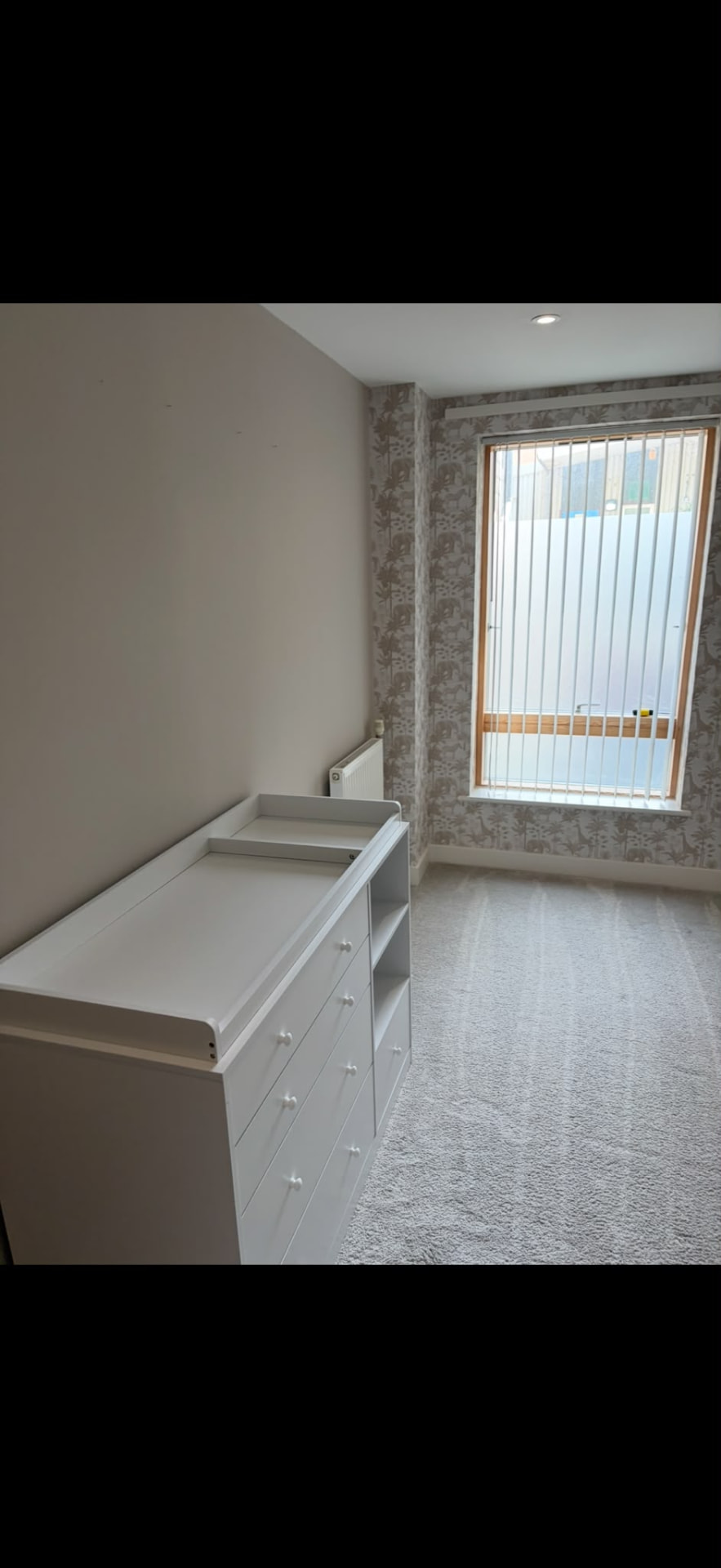 Nursery corner with wallpapered window wall and freshly painted ceiling and skirting, Hove